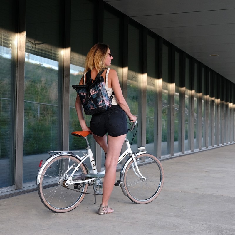 Frau mit kleinem Rucksack Retro Palma neben ihrem Fahrrad
